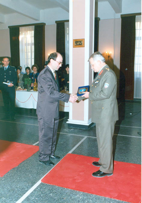 Hellenic Army War College (1998): The Commandant of the War College is presenting Dr. Theodore Liolios with an honoring distinction for his teaching and research 